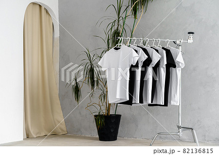 Row of black and white t-shirts hanging on rack Row of black and white t-shirts hanging on rack 82136815