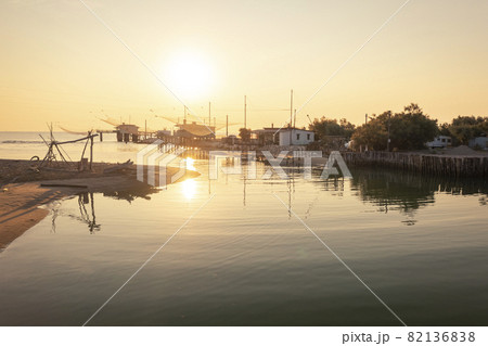 Nice panoramic view of fishing huts at sunrise near Ravenna 82136838