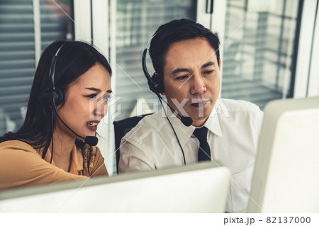 Business people wearing headset working actively in office 82137000