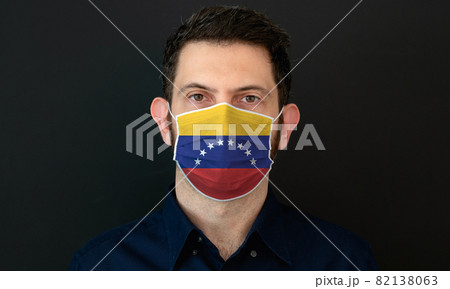 Man wearing Venezuelan flag protective medical face mask. 82138063