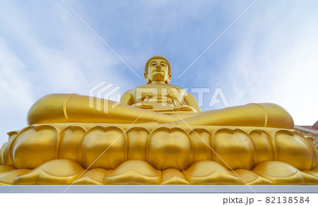 The Giant Golden Buddha in Wat Paknam Phasi Charoen Temple in Phasi Charoen district at noon, Bangkok urban city town, Thailand. Tourist attraction landmark. 82138584