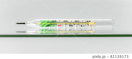 Thermometer lying on a glass surface. Thermometer lying on a glass surface. 82139173