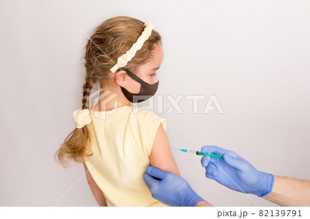A nurse is giving vaccinations to patients with a syringe. White background. Close-up shot of injection against covid19. A nurse is giving vaccinations to patients with a syringe. White background. Close-up shot of injection against covid19. 82139791