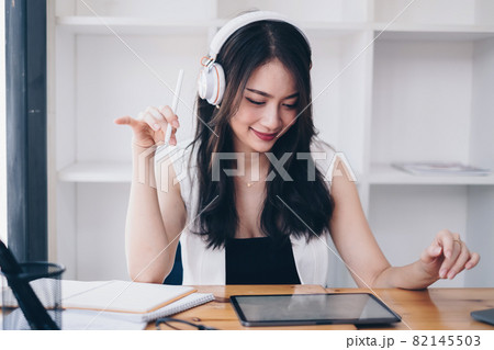 Young undergraduate student studying online class by laptop computer 82145503
