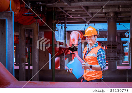 Industry engineer under checking the industry cooling tower air conditioner is water cooling tower air chiller HVAC of large industrial building to control air system. 82150773
