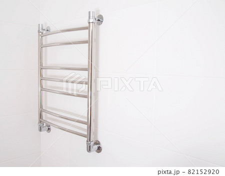 Modern stainless steel heated towel rail in the bathroom. Plumbing heating device, copy space for text 82152920