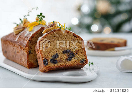 Beautiful delicious homemade Christmas dried fruit cake on grey table with decorating items for celebrating festive season. 82154826