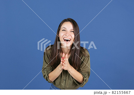 Cropped studio shot of laughing woman isolated over blue background, happiness 82155667