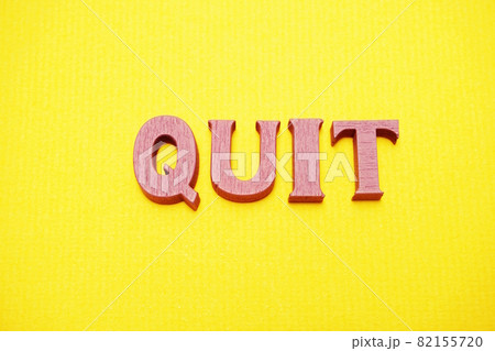 Top view Quit letters alphabet letters on Yellow background Top view Quit letters alphabet letters on Yellow background 82155720