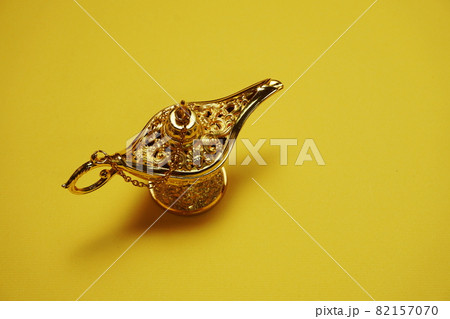 golden magic lamp with space copy on yellow background golden magic lamp with space copy on yellow background 82157070