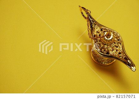 golden magic lamp with space copy on yellow background golden magic lamp with space copy on yellow background 82157071