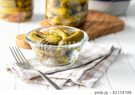 Small pickles. Marinated pickled cucumbers in bowl. 82158786