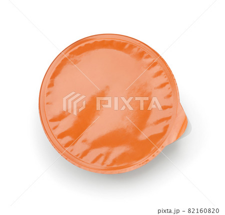 Top view of disposable plastic sauce cup with blank orange foil cover Top view of disposable plastic sauce cup with blank orange foil cover 82160820