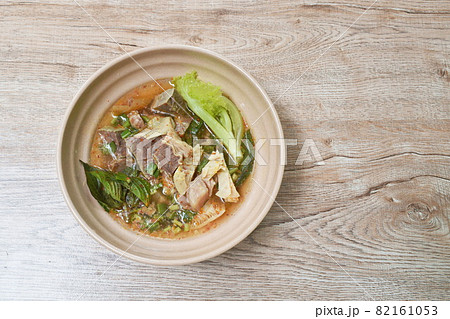 hot and spicy beef meat and organ with tamarind and Thai herbs soup on bowl 82161053