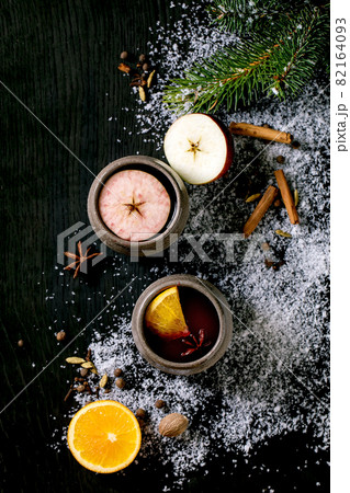 Hot mulled wine with spices and Christmas decorations 82164093