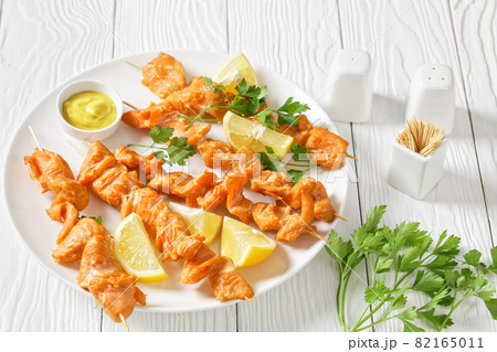 juicy grilled salmon kebabs with lemon and parsley 82165011