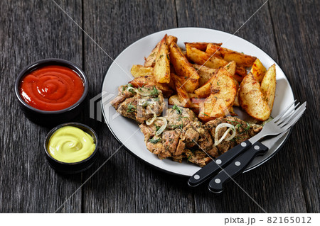 Grilled Pork Shoulder Steaks with potato wedges Grilled Pork Shoulder Steaks with potato wedges 82165012