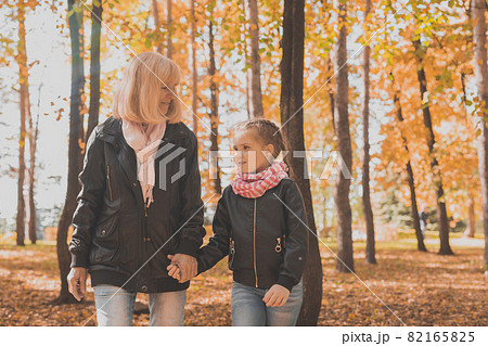 Grandmother with granddaughter in autumn park. Generation and family concept. 82165825