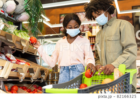 African American Couple Buying Groceries Wearing Face Masks In Supermarket African American Couple Buying Groceries Wearing Face Masks In Supermarket 82166325