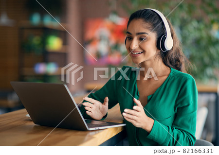 Attractive indian lady having video call at cafe 82166331