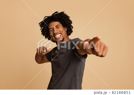 Joyful Young African American Guy Poiting At Camera With Two Hands 82166851