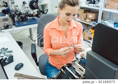 Woman working on label printing machine 82166973