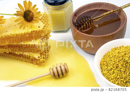Fresh flower honey in a wooden bowl, spoon, pollen and honeycomb. vitamin food for health and life 82168705