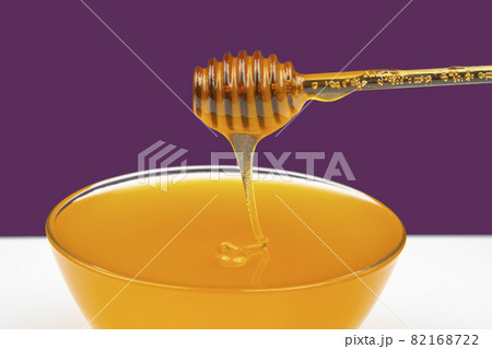 fresh honey drips from a spoon into a plate. organic vitamin health food fresh honey drips from a spoon into a plate. organic vitamin health food 82168722