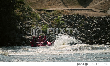 Unknown people practice rafting on inflatable raft on rumbling whitewater river Unknown people practice rafting on inflatable raft on rumbling whitewater river 82168829