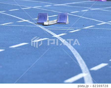 Starting blocks on blue running tracks lanes at track and field stadium. Sport accessory. 82169728