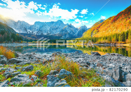 Astonishing view of Fusine lake with Mangart peak on background Astonishing view of Fusine lake with Mangart peak on background 82170290