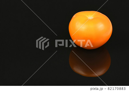 Yellow tomato isolated on black mirror Yellow tomato isolated on black mirror 82170883