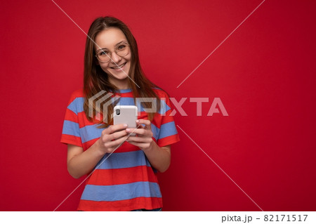 Photo shot of attractive positive good looking young woman wearing casual stylish outfit poising Photo shot of attractive positive good looking young woman wearing casual stylish outfit poising 82171517