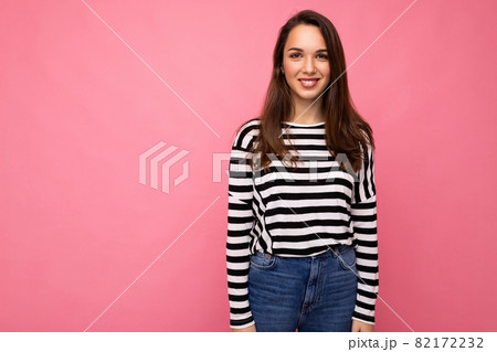 Portrait of positive cheerful fashionable woman in casual clothes isolated on pink background with Portrait of positive cheerful fashionable woman in casual clothes isolated on pink background with 82172232