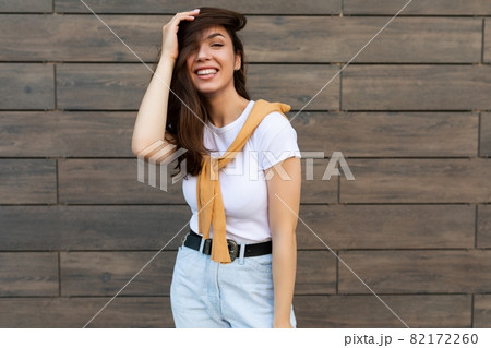 Portrait of successful smiling joyful happy young brunet woman wearing casual white t-shirt and Portrait of successful smiling joyful happy young brunet woman wearing casual white t-shirt and 82172260