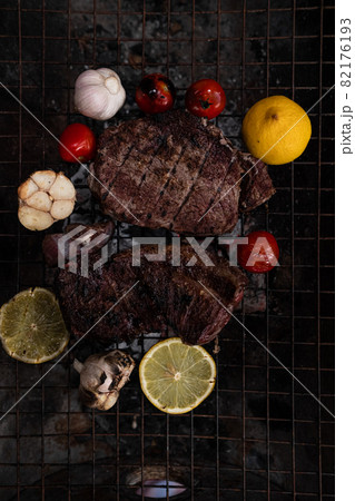 Vegetables and meat on the grill on hot coals with smoke Vegetables and meat on the grill on hot coals with smoke 82176193