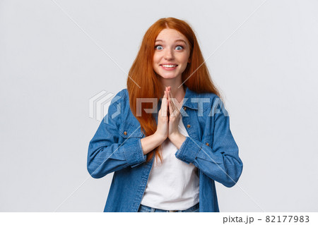 Excited happy cute redhead girl begging for help and receive positive answer, pleading and smiling hopeful feeling relieved friend lend hand with problem, standing white background cheerful 82177983