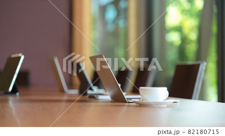 Laptop computer stand on wooden meeting table Laptop computer stand on wooden meeting table 82180715