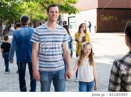 Dad walking by the hand with smiling girl Dad walking by the hand with smiling girl 82183983