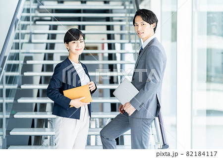 通路で会話をするビジネスパーソン 82184117