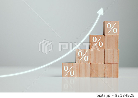 Interest rate financial and mortgage rates concept. The economy is improving. Wooden blocks with Icon percentage symbol and arrow pointing up. 82184929