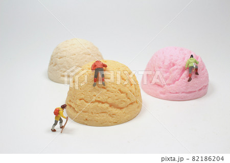 the fun of Mini people climbing the giant ice cream 82186204