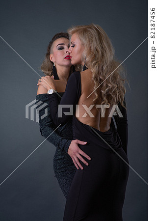 Two young attractive women with problem skin faces posing in studio 82187456