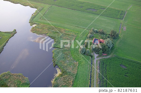 Agricultural landscape of Friesland, one of the northern provinces of the Netherlands - Friesland from above - Local farm with solar panels on roof 82187631