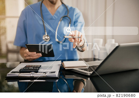 Doctor working with a tablet search for medical information at the hospital office during the day. 82190680