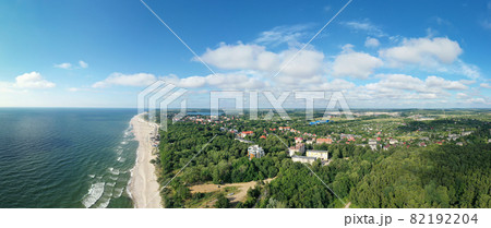 Baltic sea coastline and green summer forest with Yantarny town . Aerial panorama view 82192204