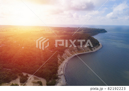 Baltic sea coastline and green summer forest on sunset . Aerial view 82192223