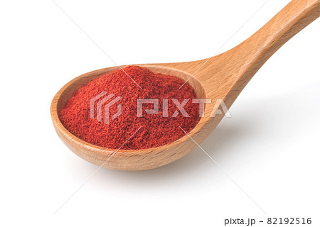 Red paprika powder in wooden spoon 82192516