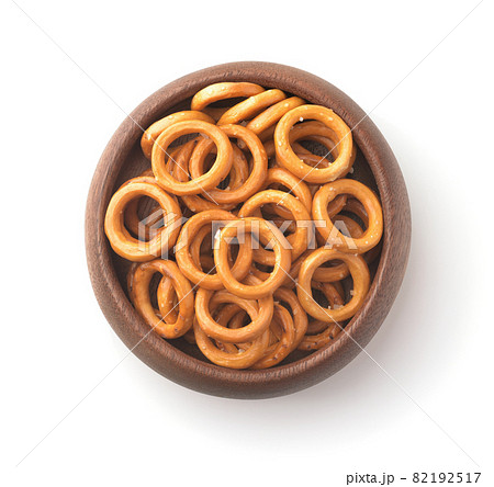 Wooden bowl of salty crispbread wheat mini rings Wooden bowl of salty crispbread wheat mini rings 82192517