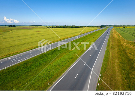 Asphalt highway through green summer field. Aerial view Asphalt highway through green summer field. Aerial view 82192716